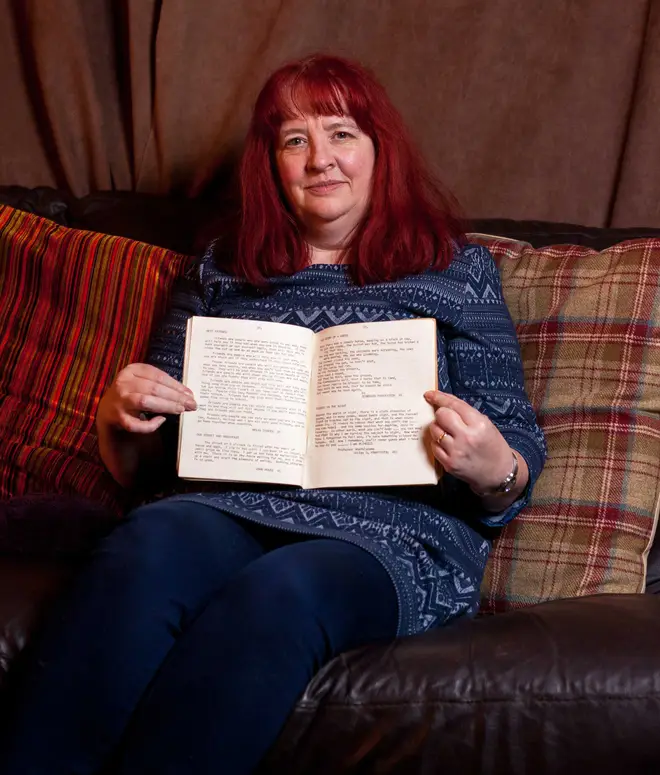 Penny Ling poses with the schoolbook she unearthed containing George Michael's poems