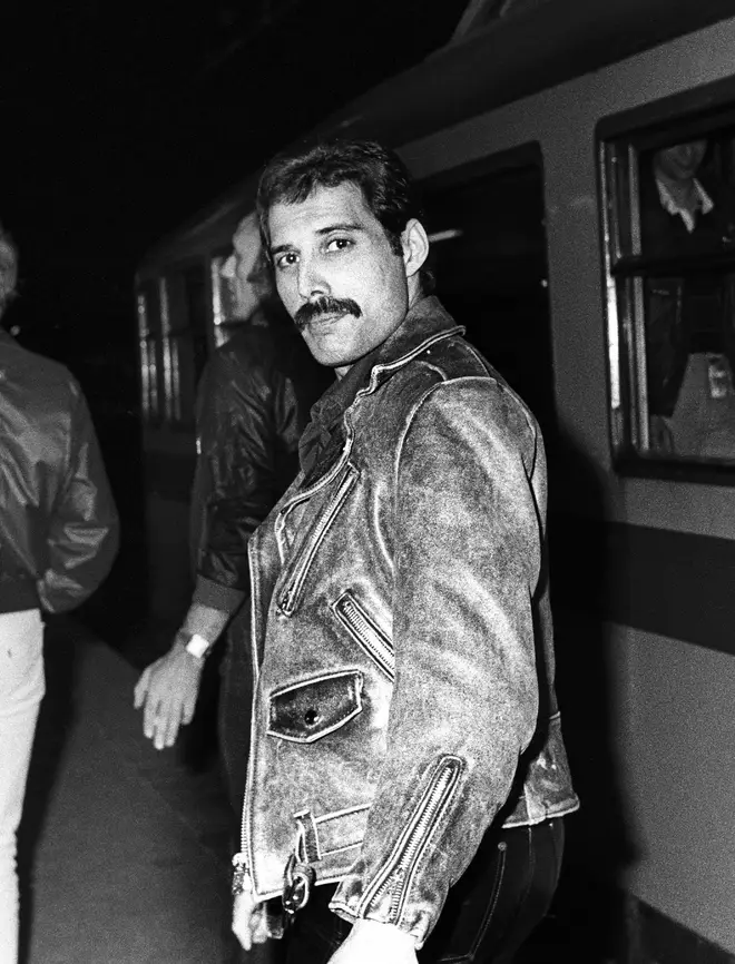 Freddie Mercury getting a train from Leiden to Amsterdam, Netherlands, after a gig at Groenoordhal, Leiden, 25th April 1982.