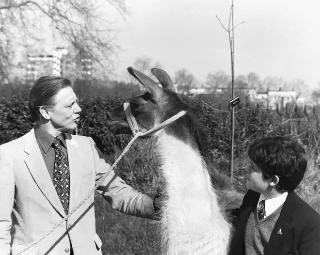 David Attenborough shows 12-year-old Patrick Flynn from Kent a Llama called Charlie, at London Zoo