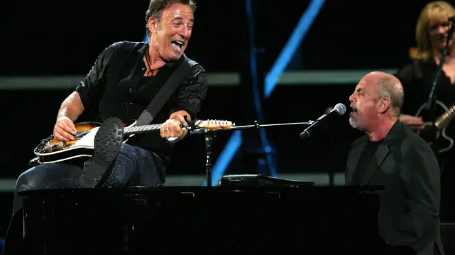 Bruce Springsteen and Billy Joel perform onstage on October 29, 2009 in New York City