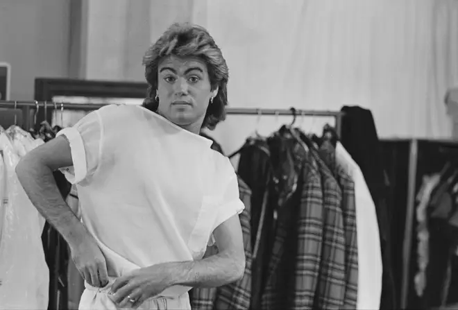 George Michael pictured changing in to his stage clothes backstage during the Australian leg of Wham!'s 1985 world tour, January 1985.