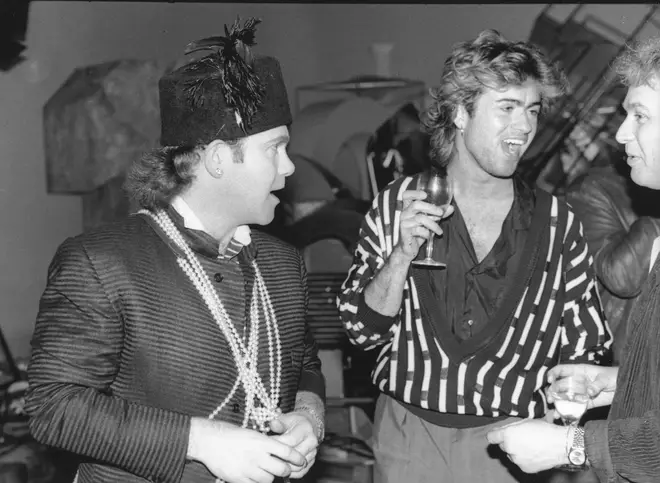 Elton John and George Michael chat in a film studio in May 1985 in London, England.