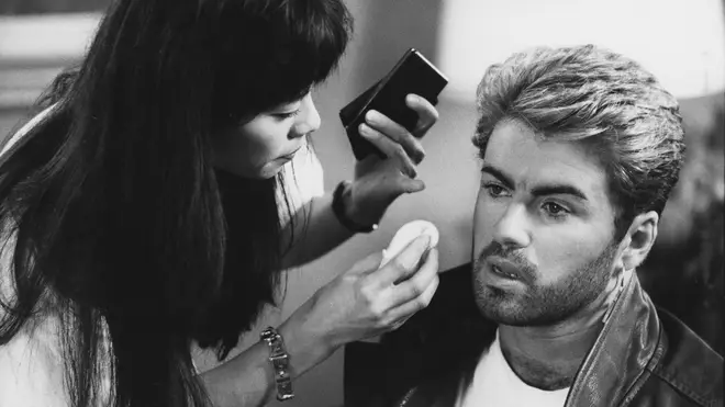 George Michael pictured receiving attention from a make up artist prior to appearing at a press conference during the Japanese/Australasian leg of his Faith World Tour, February-March 1988.