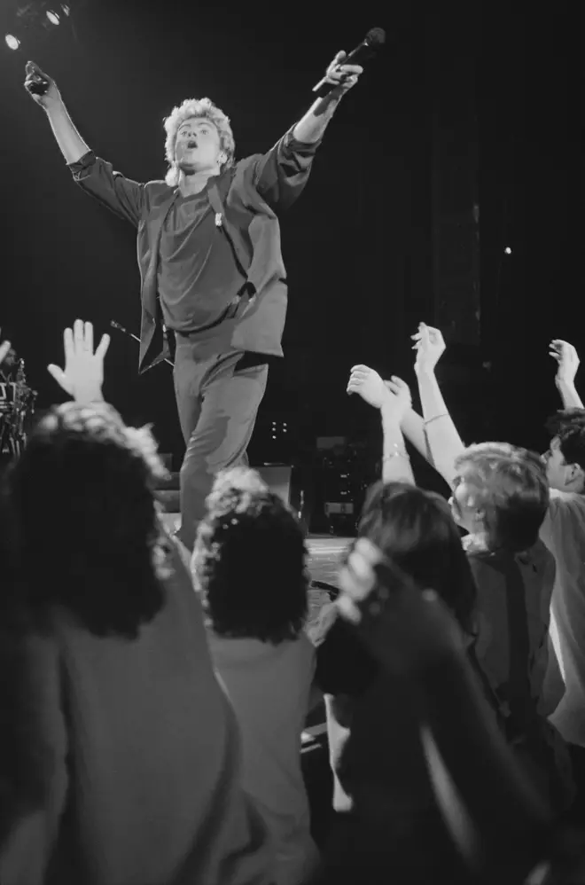 George Michael performs live on stage with pop duo Wham! in front of fans during their 1985 world tour in January 1985.