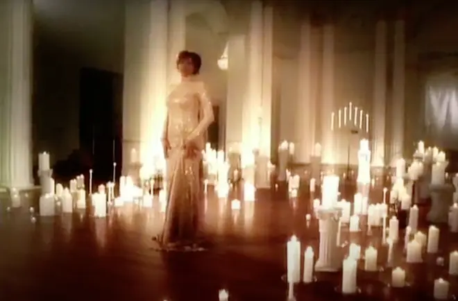 The unreleased music video, shot in 2003, sees Whitney sing the classic Christmas carol surrounded by a blanket of candles.