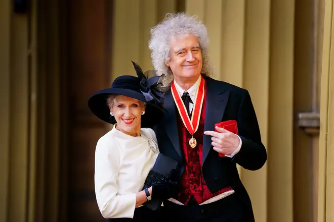 Brian showing off his new honour alongside wife Anita Dobson. (Photo by Victoria Jones - WPA Pool/Getty Images)