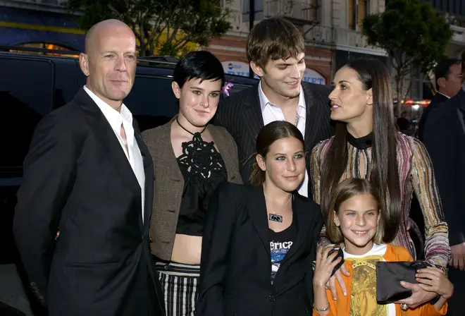 Former couple Bruce Willis and Demi Moore share three daughters together — (L to R) Rumer, 34; Scout, 31; and Tallulah, 29 (the family pictured together in 2003)