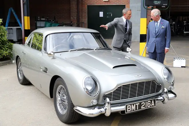 Daniel Craig and Prince Charles inspect the Aston Martin.