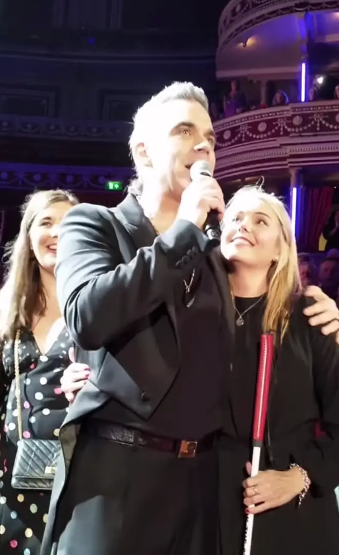The singing legend was performing at The Royal Albert Hall when he picked blind fan, Claire Sisk, out of the audience and dedicated 'She's The One' to her as he embraced her on stage.