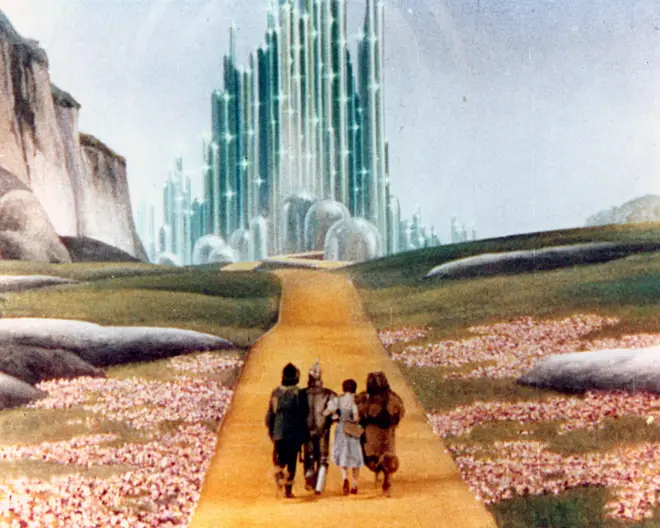 Dorothy (Judy Garland) and friends walking the Yellow Brick Road in 1939 fantasy film The Wizard Of Oz.
