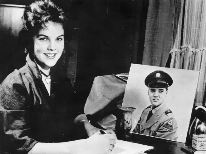 16-year old Priscilla Beaulieu with a portrait of Elvis Presley in 1960.