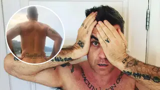 Robbie Williams strips off to show his tattoos
