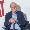 Sir Michael Caine used a walking stick to make a rare appearance on the red carpet of his latest, and possibly last, film.