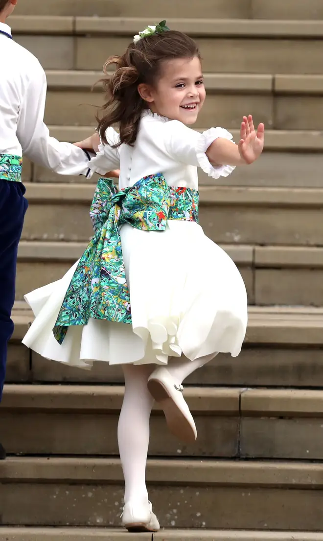 Theodora Williams waves as she arrives ahead of the wedding of Princess Eugenie of York and Mr. Jack Brooksbank at St. George's Chapel on October 12, 2018