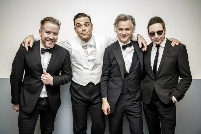 Guy Chambers with Robbie Williams (middle)
