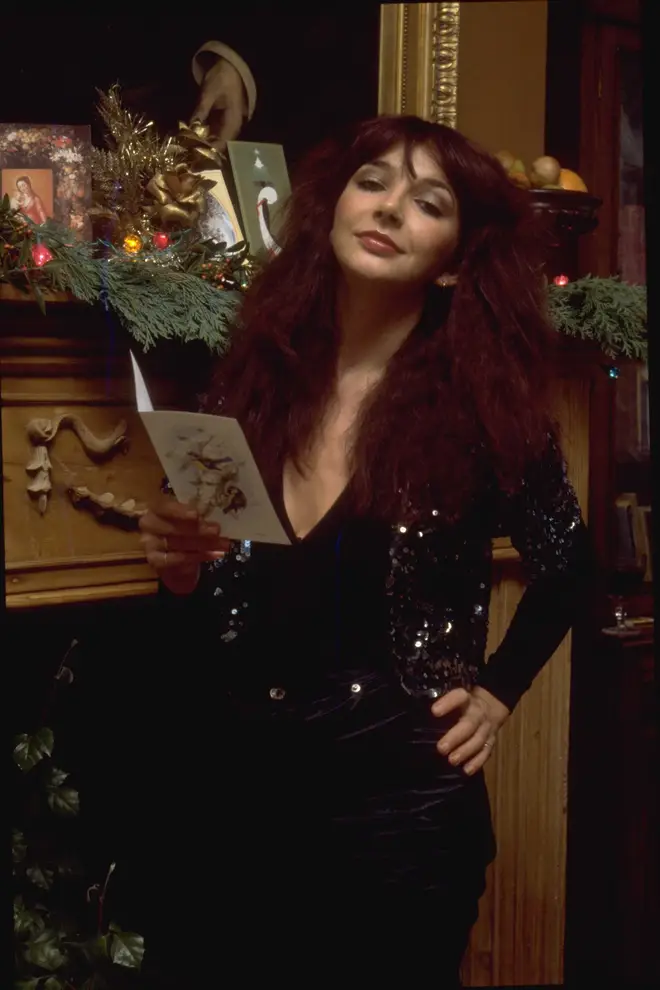Musician Kate Bush posed next to a decorated fireplace in promotion of her one-off Christmas television special, Kate, circa 1979. (Photo by TV Times via Getty Images)