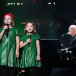 Billy Joel made his final concert before Christmas an especially festive one, bringing out his two daughters to sing cute version of 'Jingle Bells'. (Photo by Myrna M. Suarez/Getty Images)