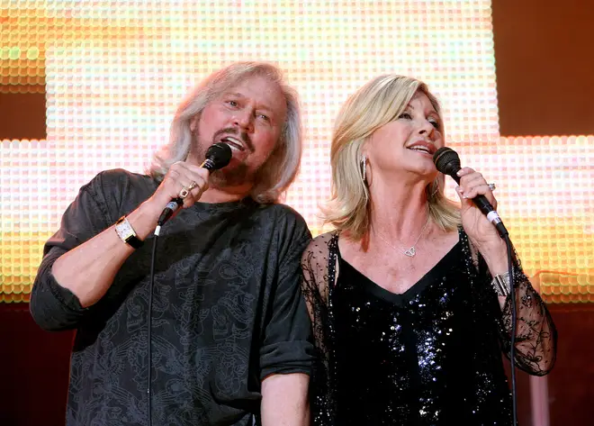 The Bee Gee, who has produced a whopping 16 No.1 songs, transformed the music landscape of the 20th century (performing with Olivia Newton-John in 2009)