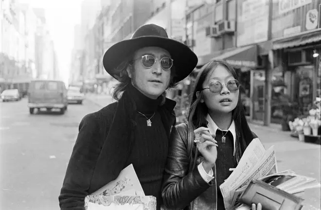 John Lennon (pictured here with May Pang in 1974) was shockingly murdered in 1980. (Photo by Peter Simins/WWD/Penske Media via Getty Images)