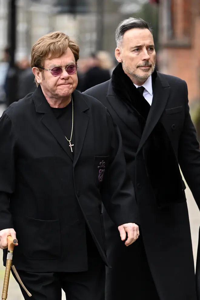 Elton John and David Furnish attend the funeral of Derek Draper