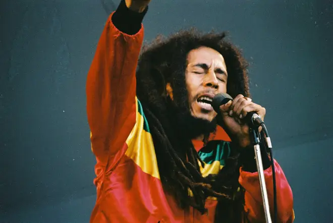 'One Love' is Bob Marley's plea for love, peace, and unity. (Photo by Pete Still/Redferns)