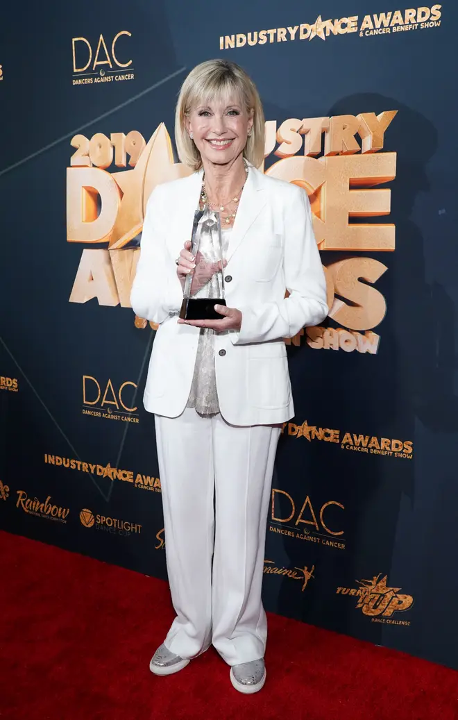 Olivia Newton-John poses with her Lifetime Achievement Award