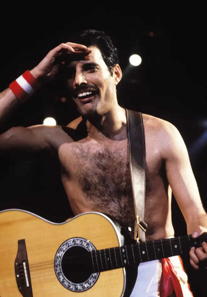 Freddie Mercury between songs and laughing with the crowd on tour with Queen in 1982.