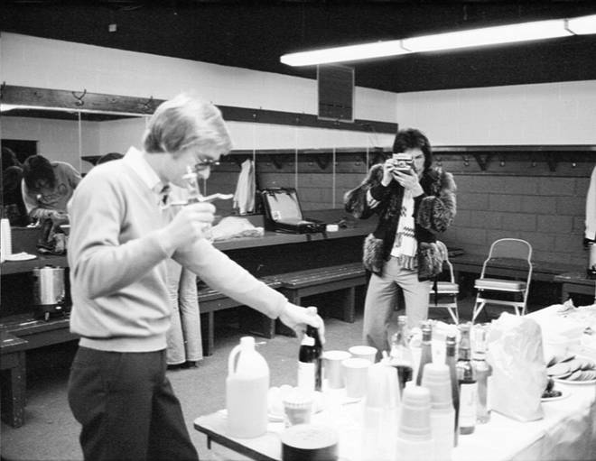 Freddie Mercury takes a photo with a Polaroid camera backstage, Los Angeles, US, circa 1977.