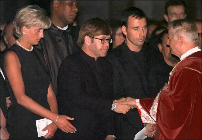 Princess Diana standing next to Elton John during the requiem mass for Italian fashion designer Gianni Versace