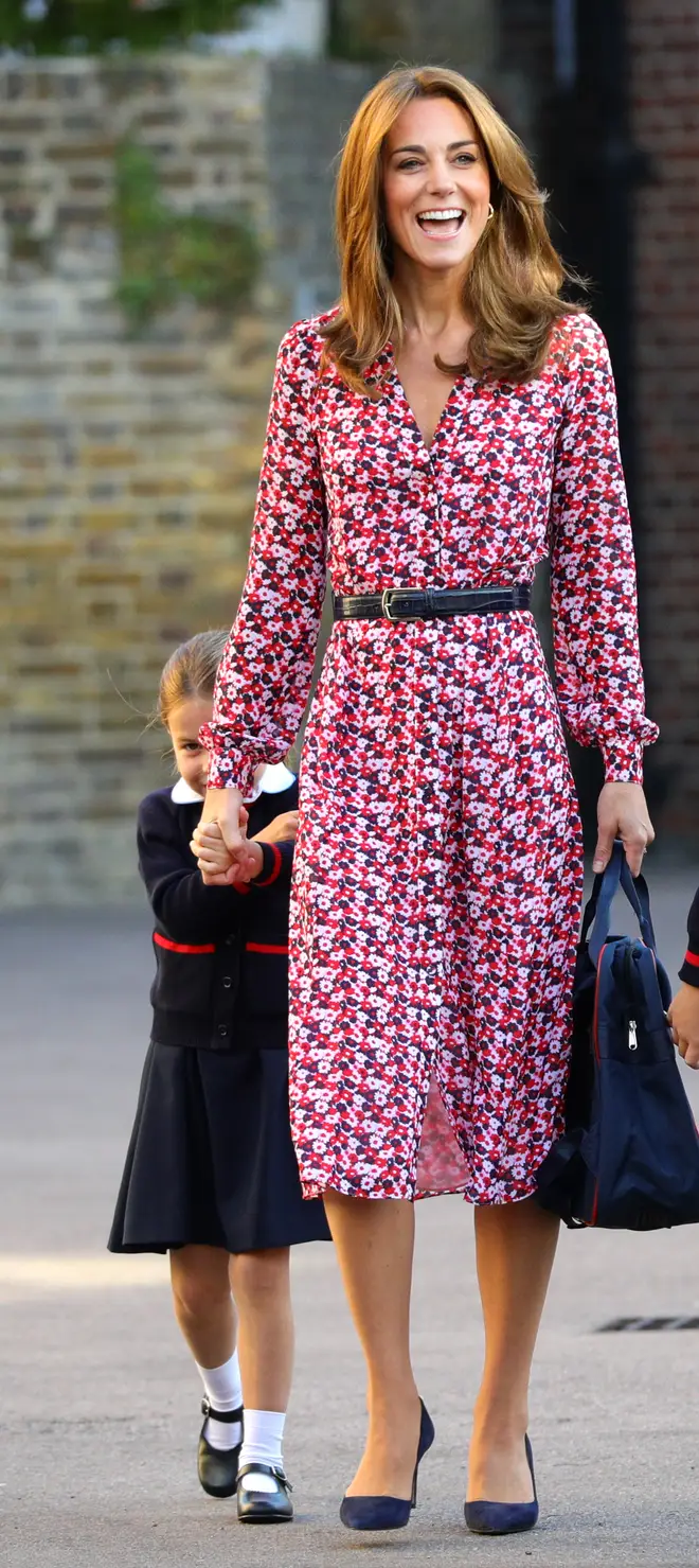 Princess Charlotte hiding behind the Duchess of Cambridge's dress