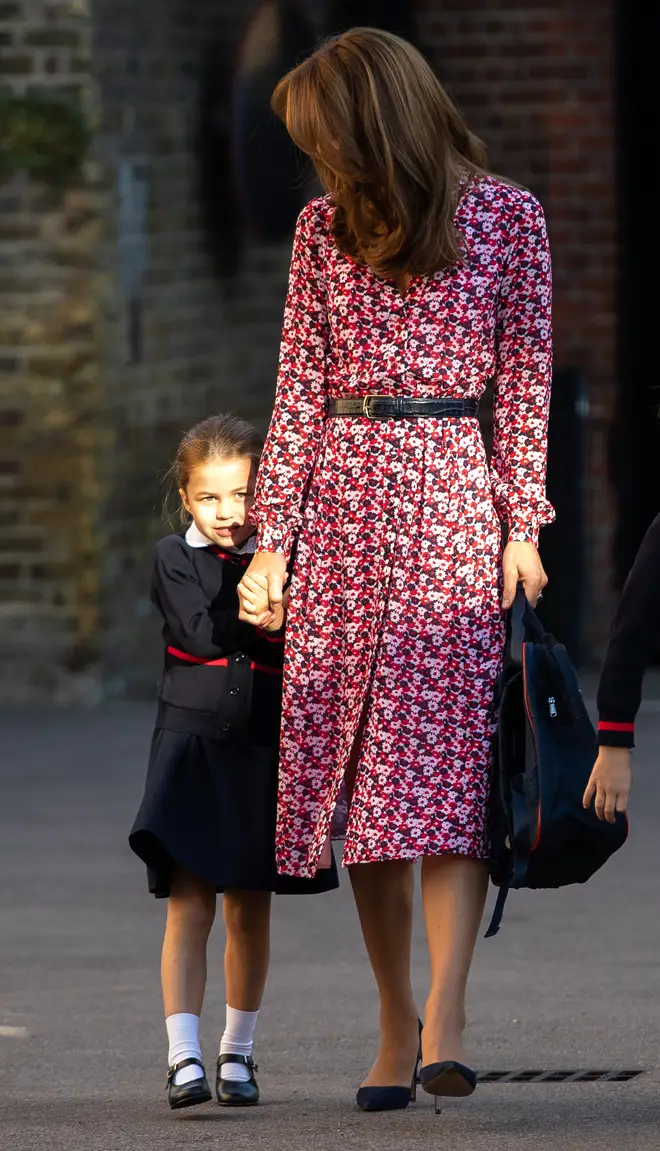 Princess Charlotte hiding behind her mother's dress on the way to school