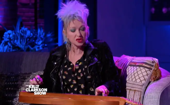 Cyndi Lauper playing her song on an Appalachian dulcimer