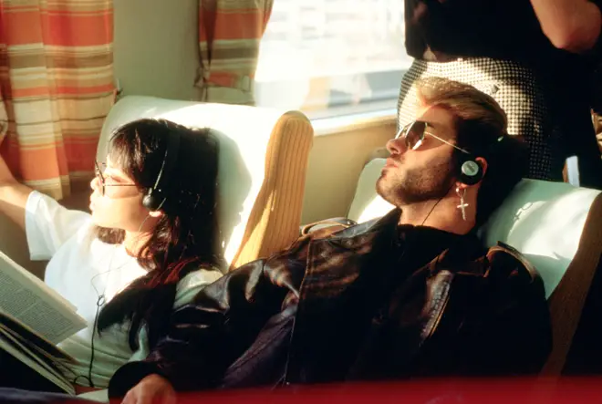 George Michael with girlfriend Kathy Yeung, on a train listening to a Walkman, Japan, March 1988.